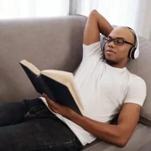 man relaxing and reading a book