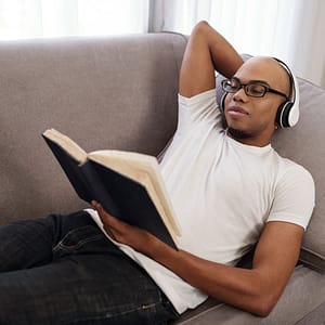 man relaxing and reading a book